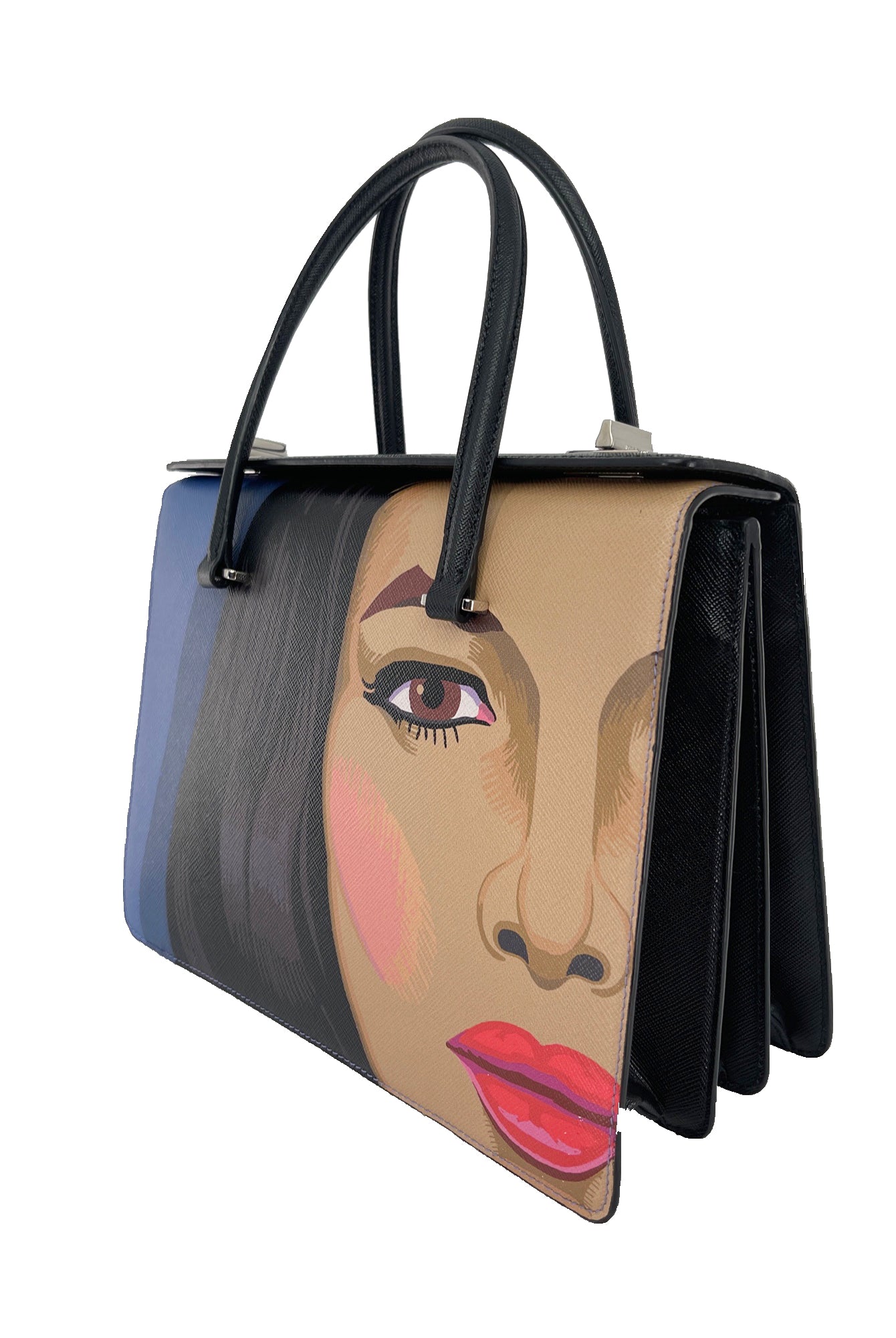 From the Spring/Summer 2014 Collection. Black leather Prada Saffiano Girl Print bag with dual rolled handles at top, silver-tone hardware, girl motif at front face, dual interior compartments, three pockets at interior walls; one with zip closure, one with flap closure and dual turn-lock closures at top. Made in Italy.